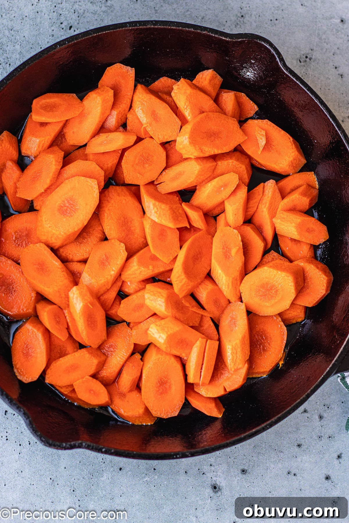 Crispy Pan-Fried Carrots with Garlic and Herbs 5 Carrot slices in a cast iron skillet.