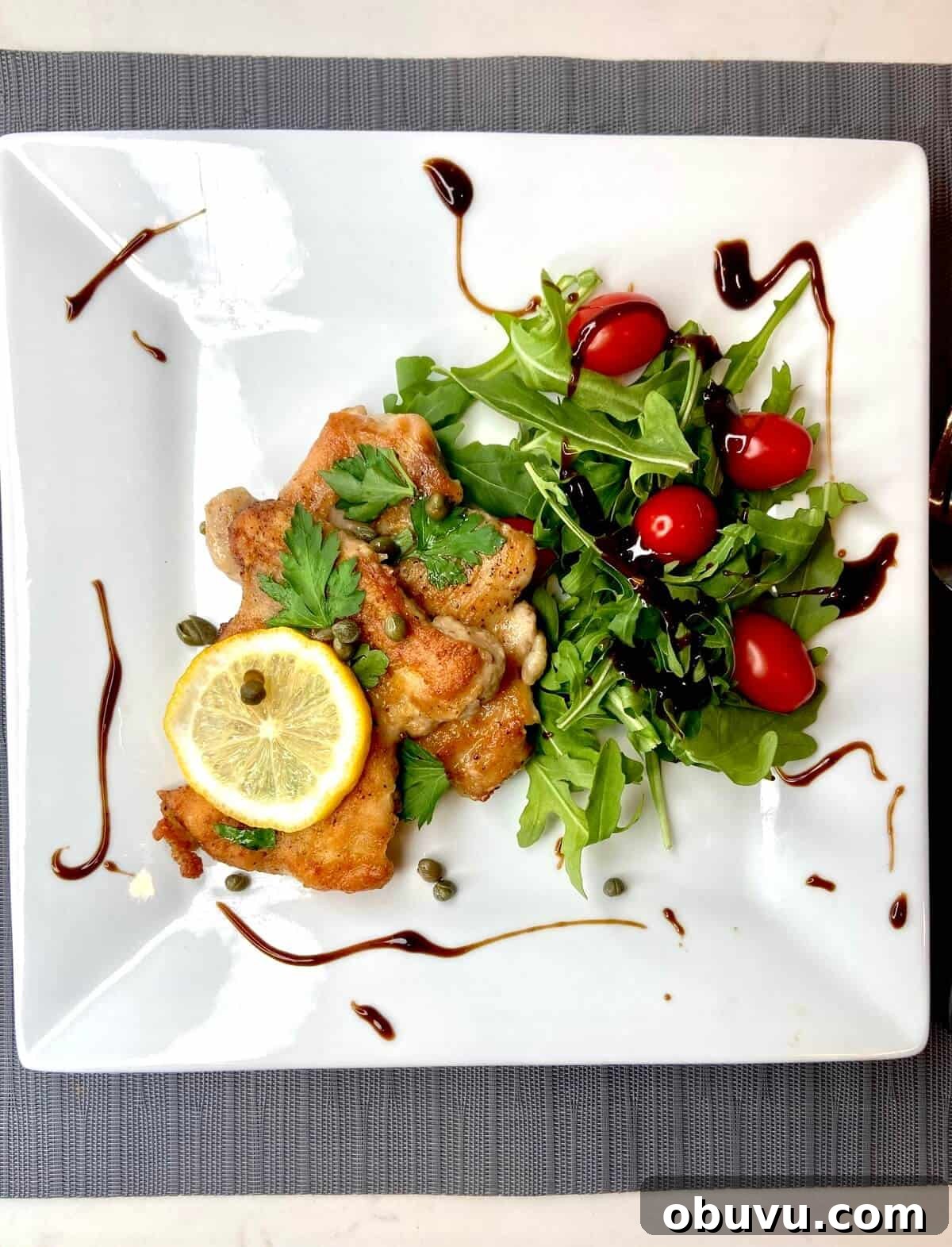 Lemon Scaloppine Recipe: Tender Veal in Zesty Lemon Sauce 5 Served on a white plate with salad.