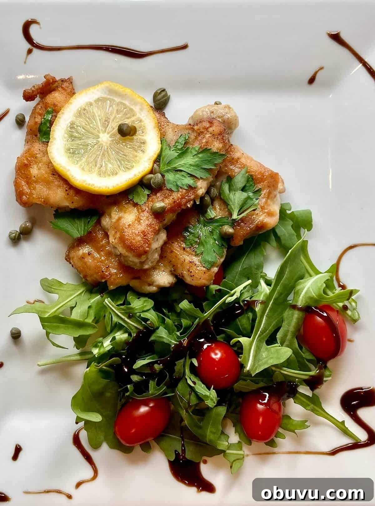 Lemon Scaloppine Recipe: Tender Veal in Zesty Lemon Sauce 9 Served with lemon and capers, and a small salad with balsamic vinegar.