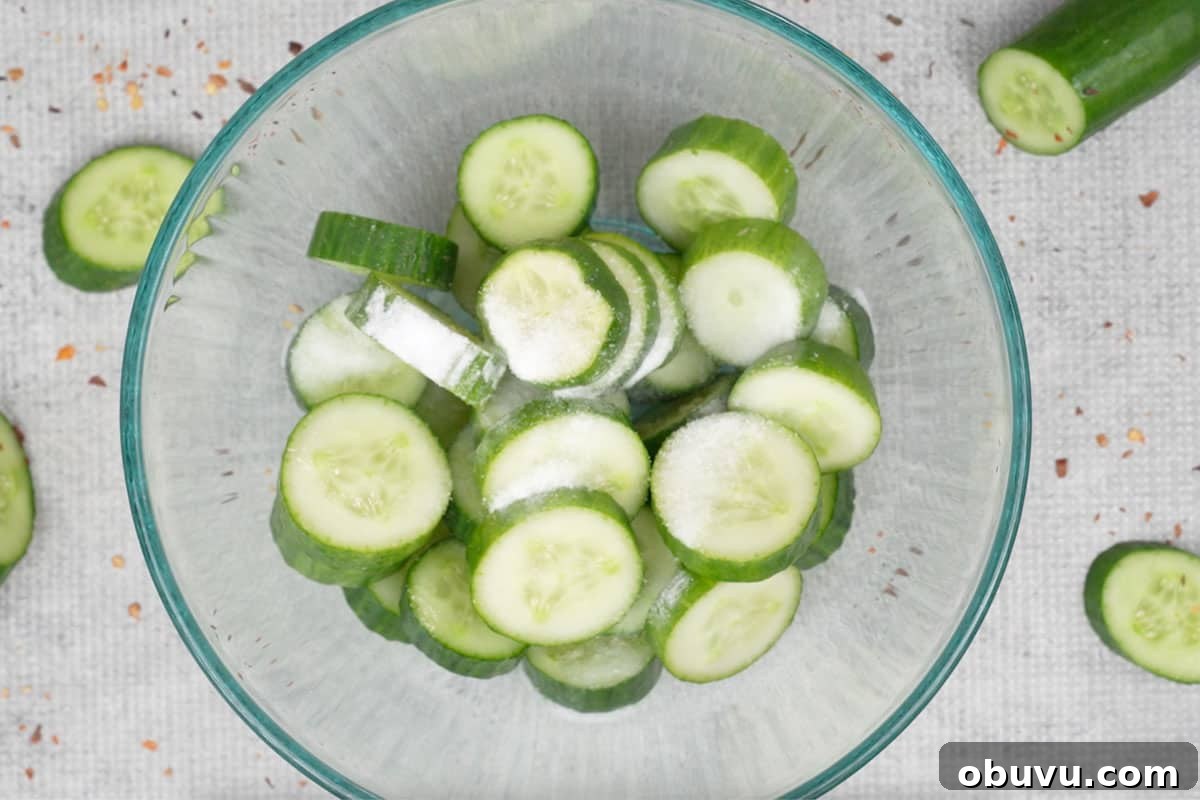 Din Tai Fung-Style Cucumber Salad Recipe That Pops 3 Cucumber and salt added to a bowl.