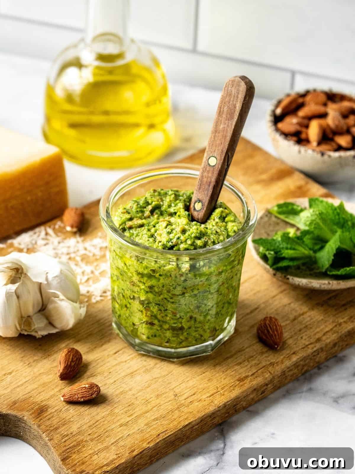 Pea and mint pesto in a mason jar on a wooden board.