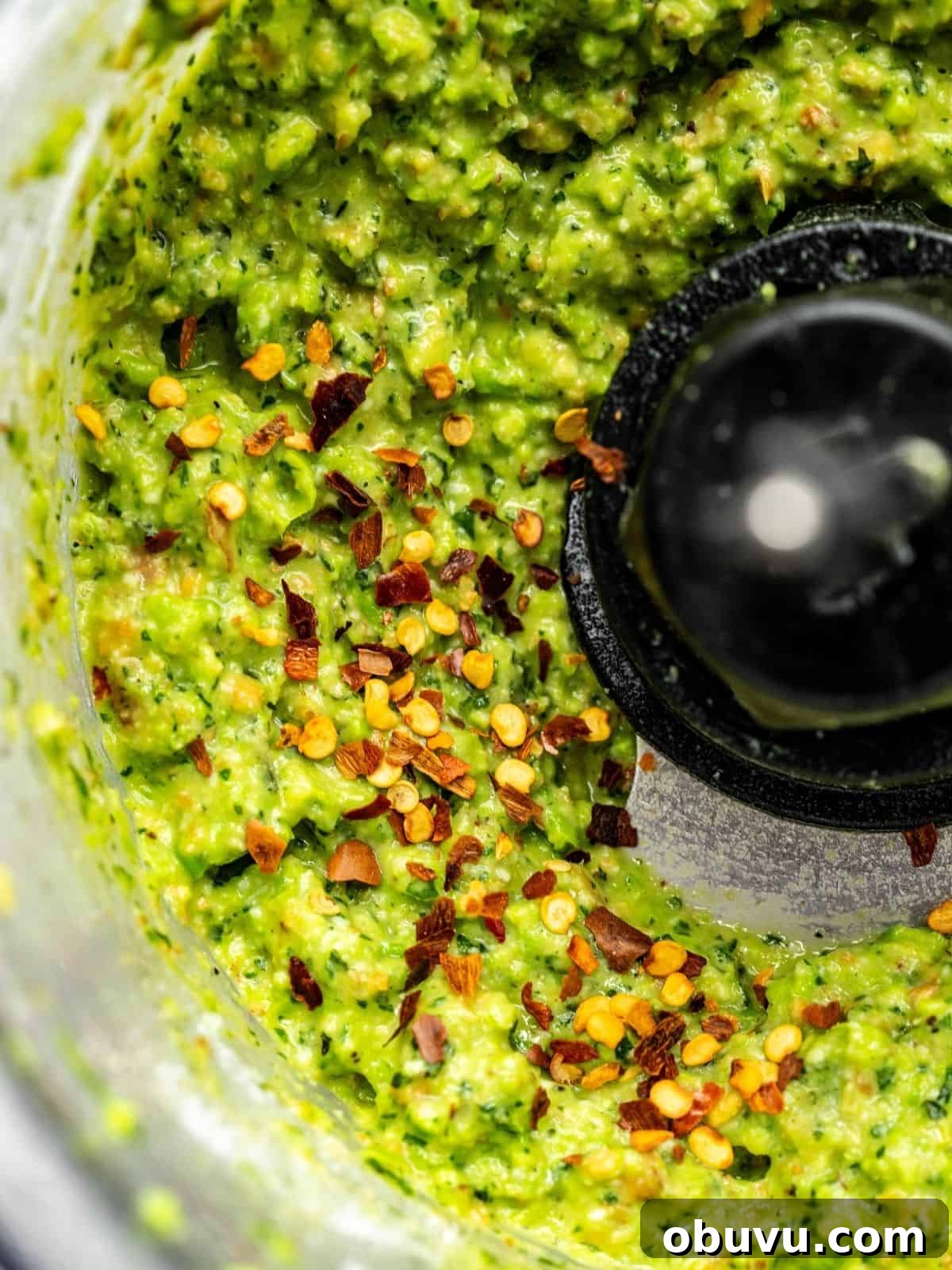 Pea pesto getting seasoned in a food processor.