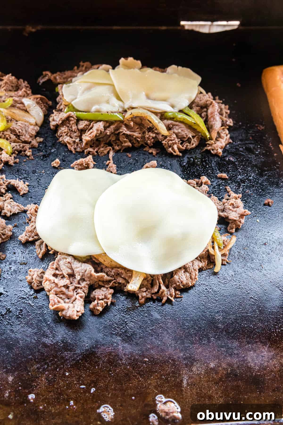 How to Make an Authentic Philly Cheesesteak on a Blackstone Griddle 7 Topping steak and vegetables with provolone cheese