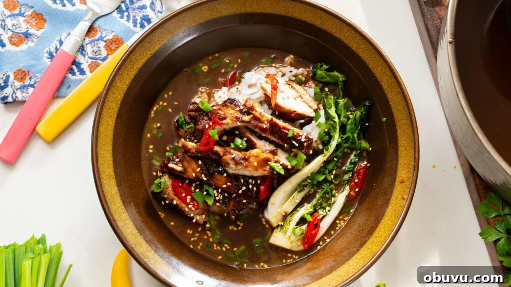 Brothy chicken and rice in a bowl with veggies and box choy.