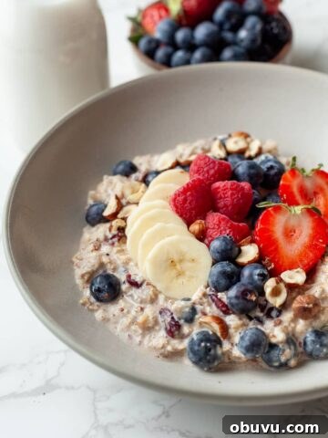 gluten free bircher muesli in a bowl topped with fresh berries