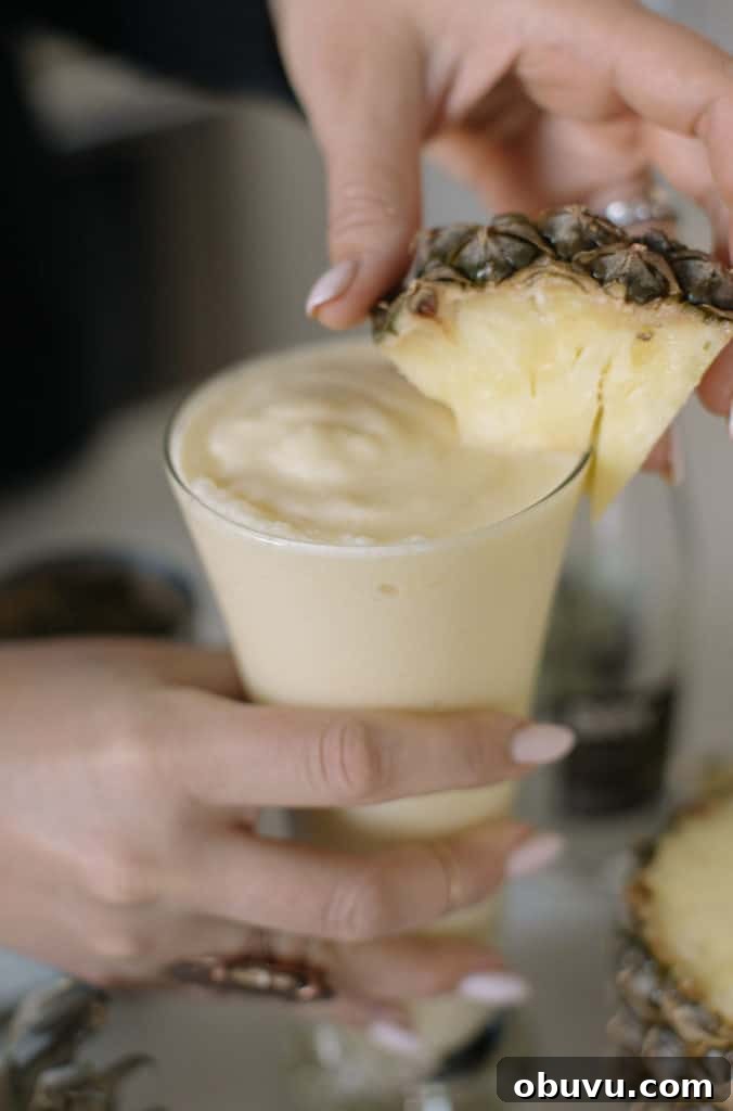 Refreshing 4th of July Cocktails and Festive Mocktails 4 Non-alcoholic pina colada close up with pineapple triangle