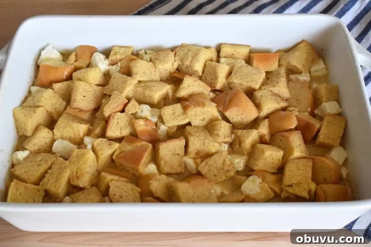 Cream Cheese Baked French Toast Casserole Recipe 7 Custard poured on top of the bread cubes in a baking dish.
