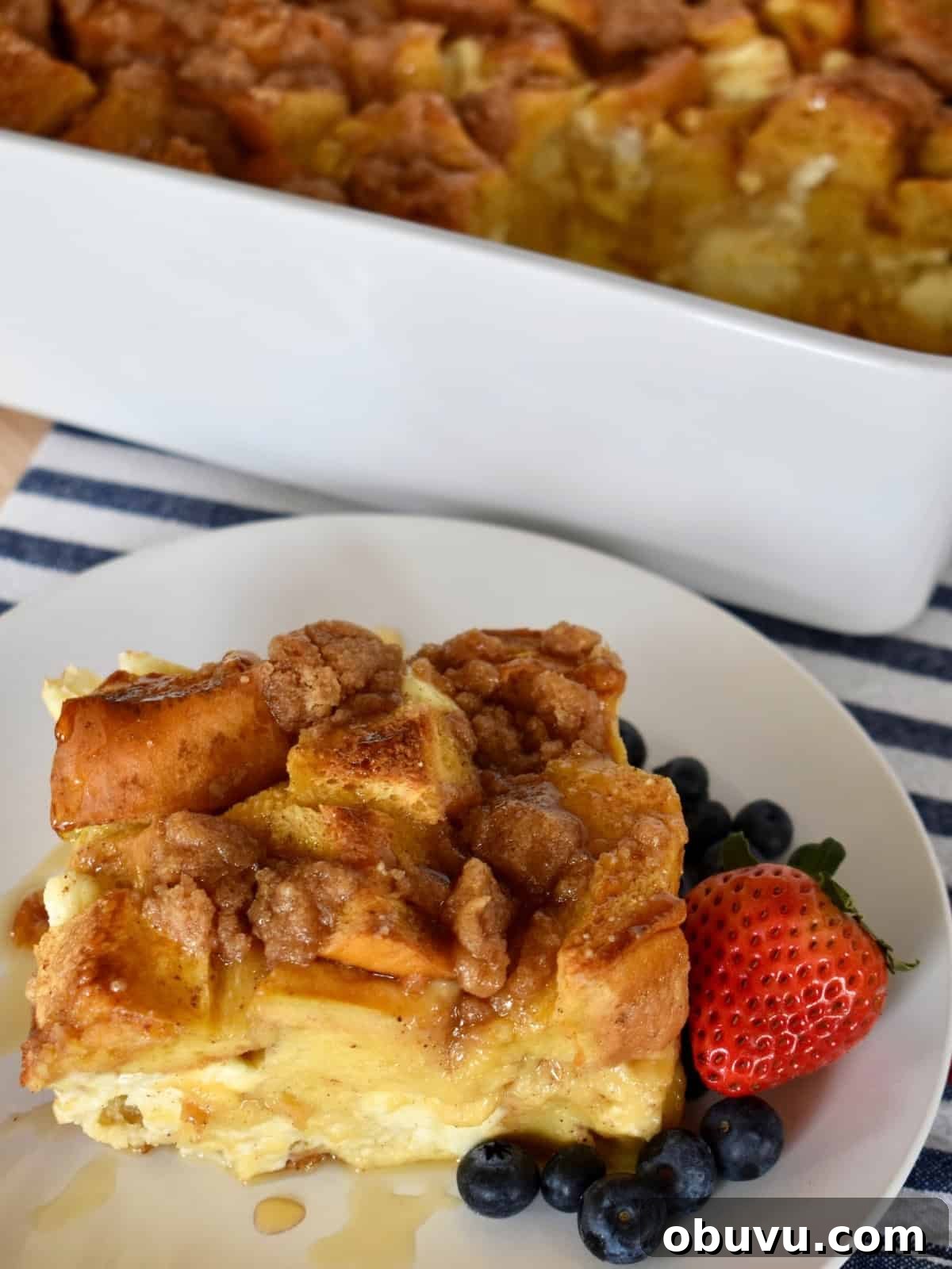 Cream Cheese Baked French Toast Casserole Recipe 9 Baked French Toast with Cream cheese on a plate with fresh berries.