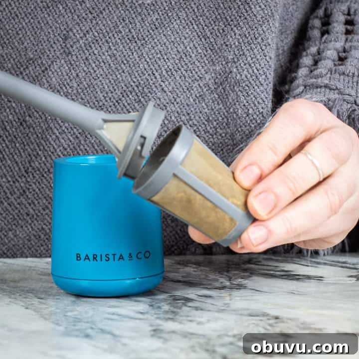 Brew It Stick Review — Is This the Ultimate Camping Coffee Maker? 7 womans hands removing the basket kid from a brew it stick camping coffee maker