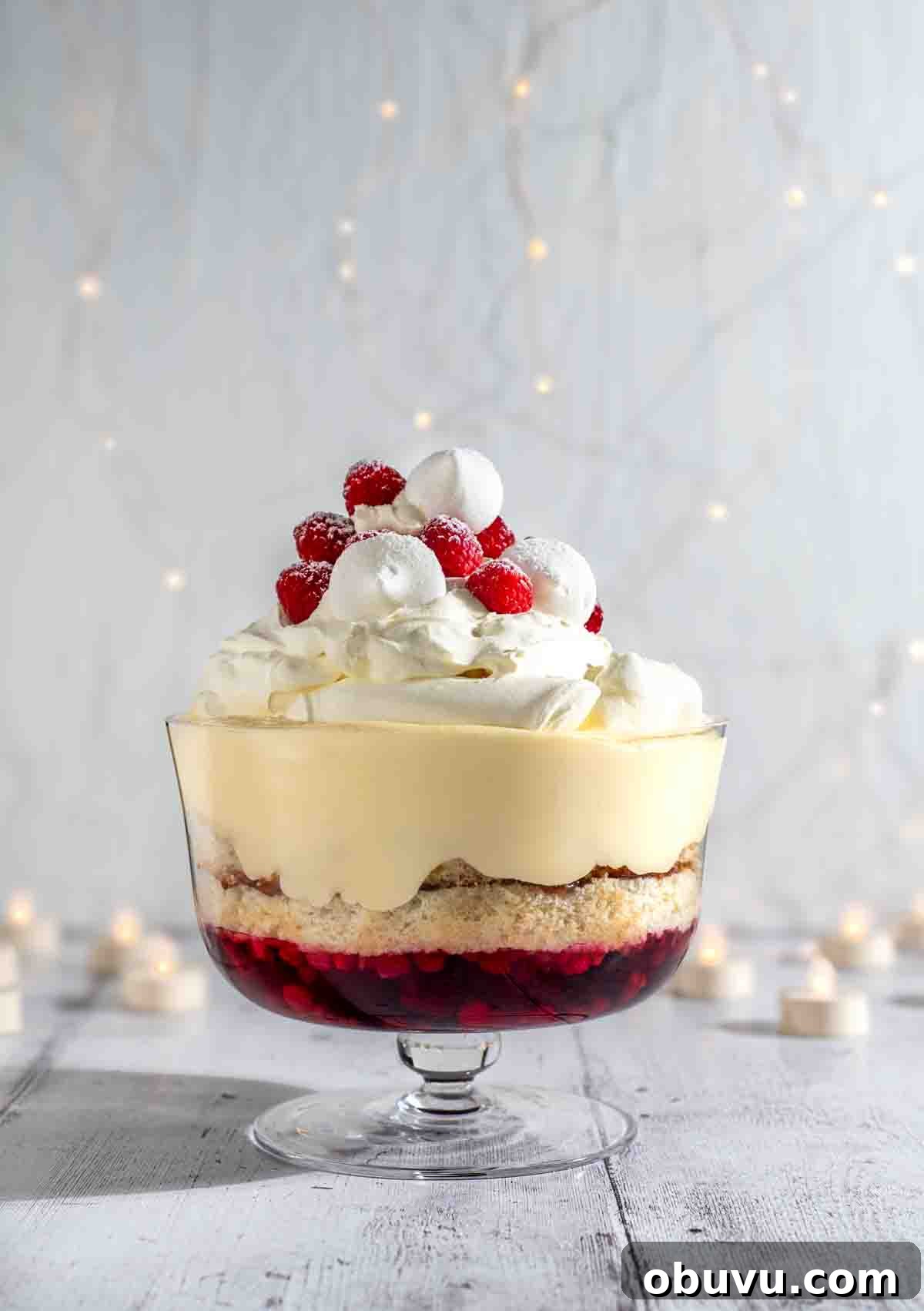 Classic English Sherry Trifle Recipe for Holiday Dessert 2 Sherry trifle on a white background surrounded by Christmas lights.