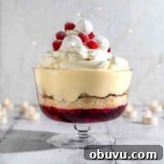 Sherry trifle on a white background surrounded by Christmas lights.