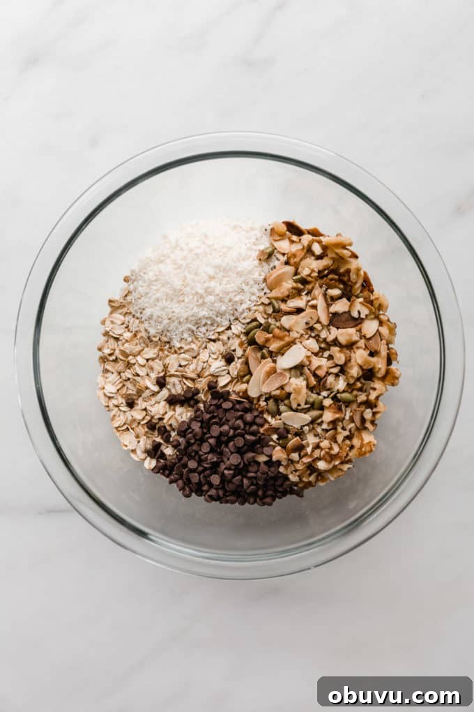 oats, nuts, coconut and chocolate chips in a mixing bowl