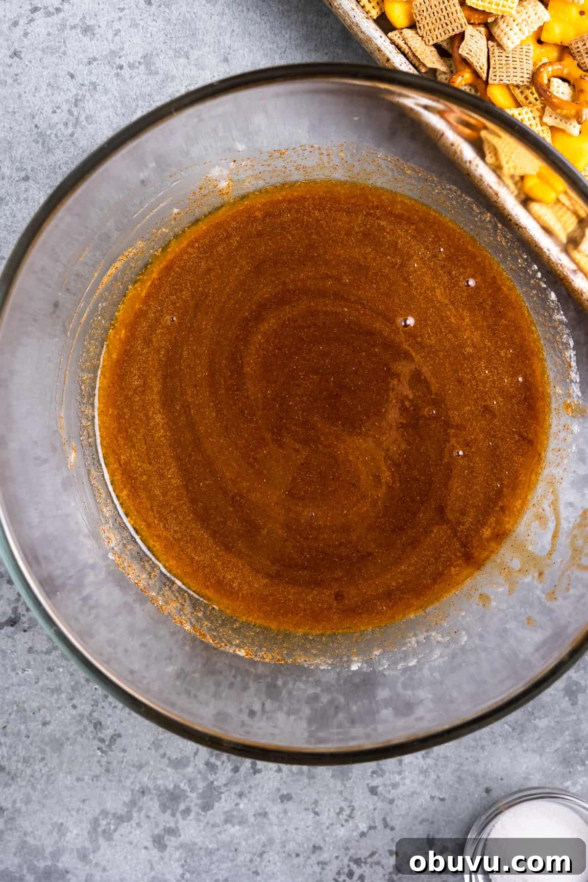 Texas Trash Spicy Chex Mix Recipe — Sweet, Smoky & Fiery 4 Spicy butter in a bowl.