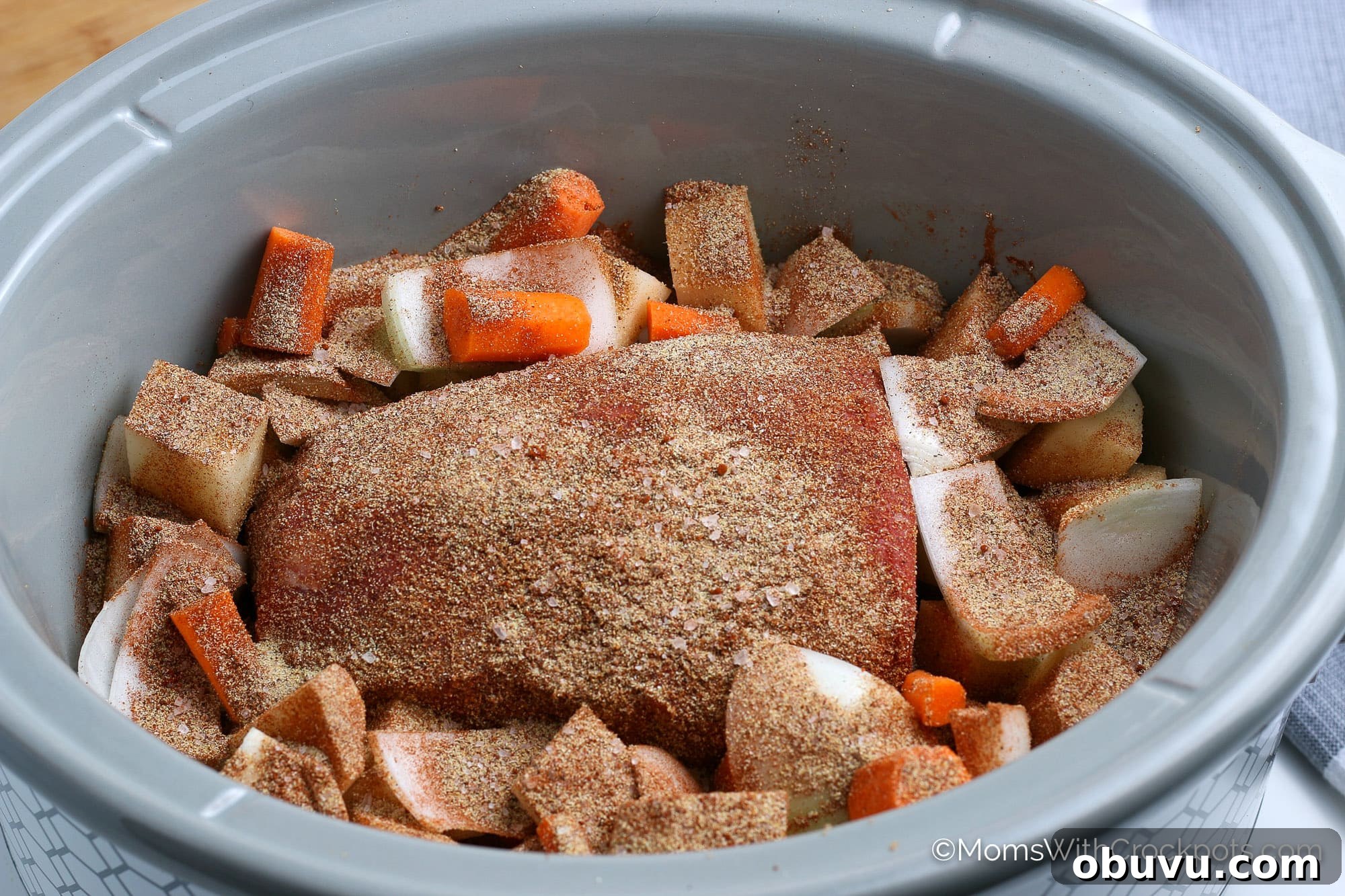 Tender Slow-Cooker Beef Roast with Garlic and Herbs 4 beef roast and veggies with seasoning in slow cooker