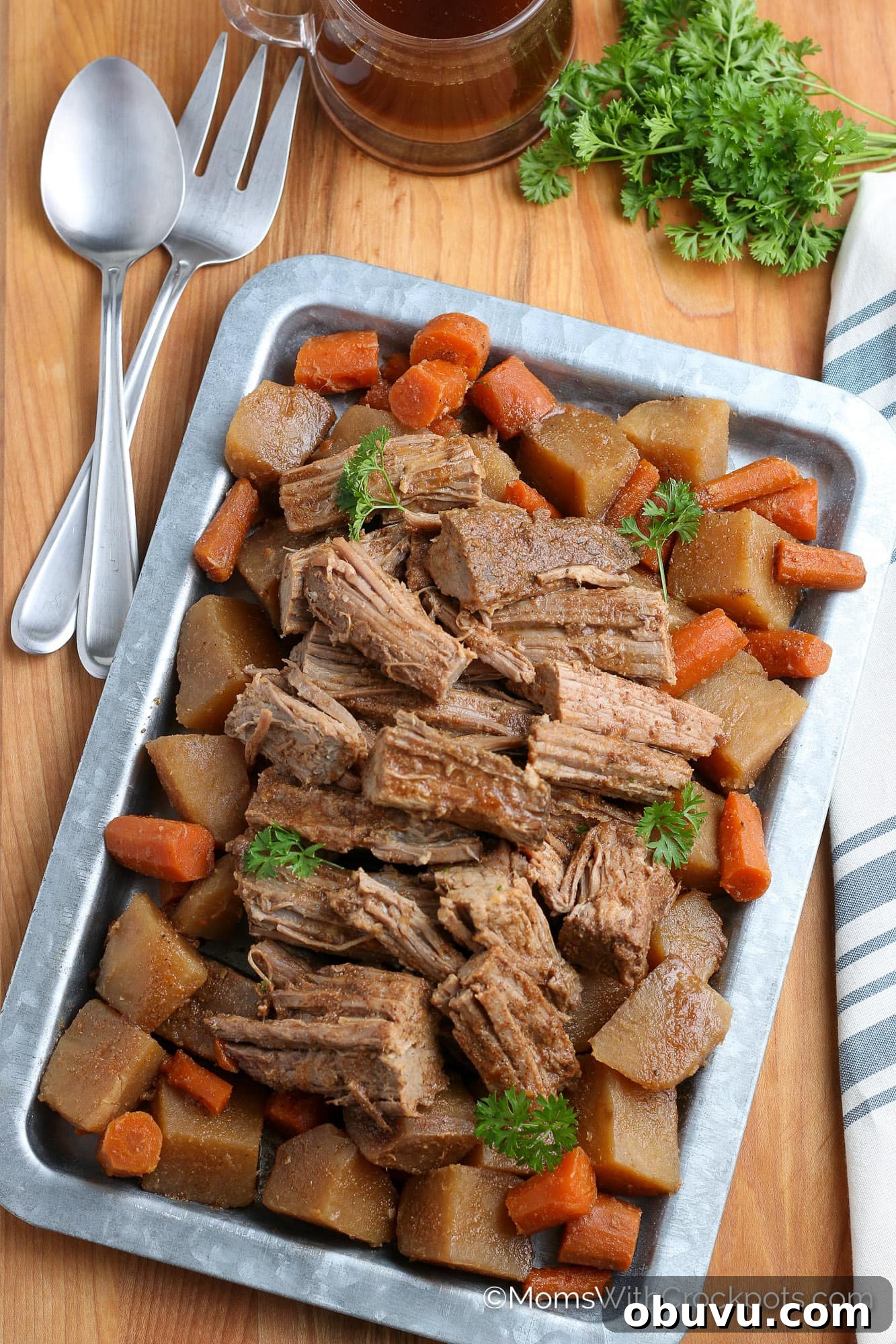 Tender Slow-Cooker Beef Roast with Garlic and Herbs 6 crock pot beef roast and veggies on tray with parsley and au jus