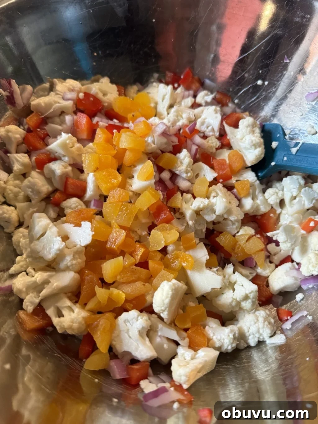 Cauliflower Crunch Salad with Honey Jalapeño Dressing Recipe 7 The diced vegetables and dried apricot bits mixed in a metal bowl