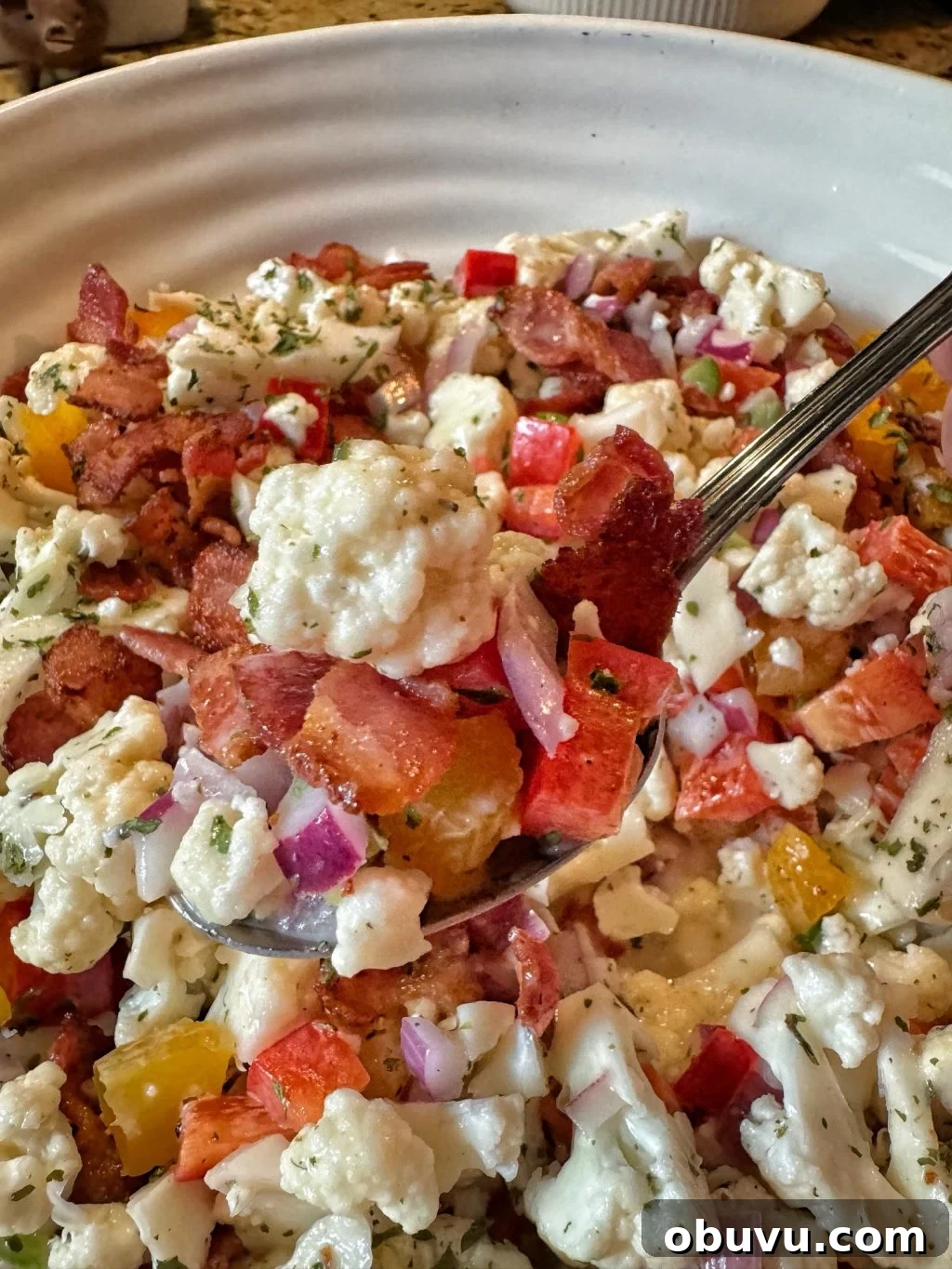 Cauliflower Crunch Salad with Honey Jalapeño Dressing Recipe 10 A close up of a spoonful of the Cauliflower Crunch Salad