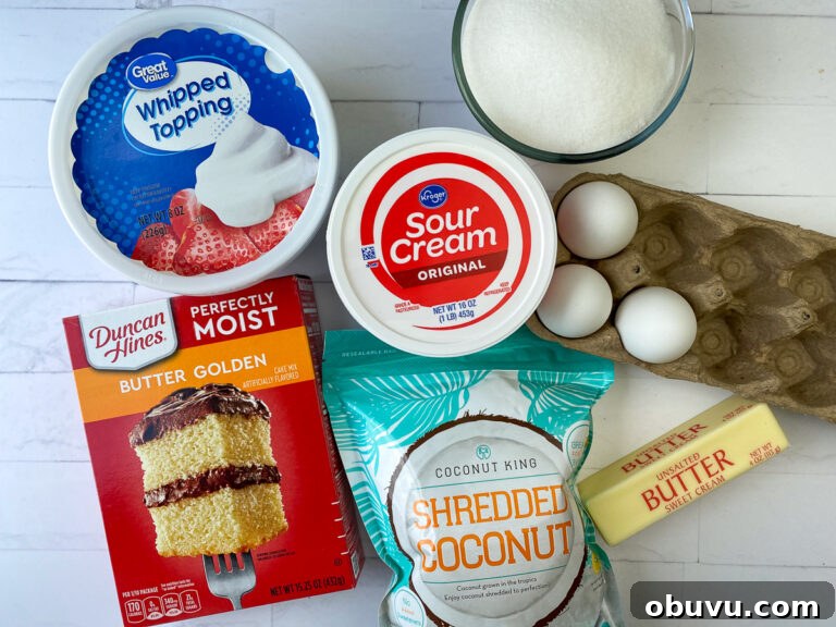 Whipped topping, sour cream, shredded coconut, sugar, eggs, butter and butter golden cake mix are the ingredients to make sour cream coconut cake on a white counter top
