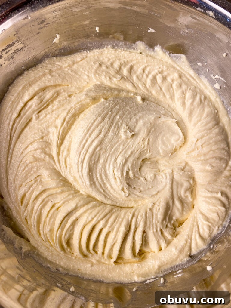 Butter yellow cake mix batter in a silver mixing bowl