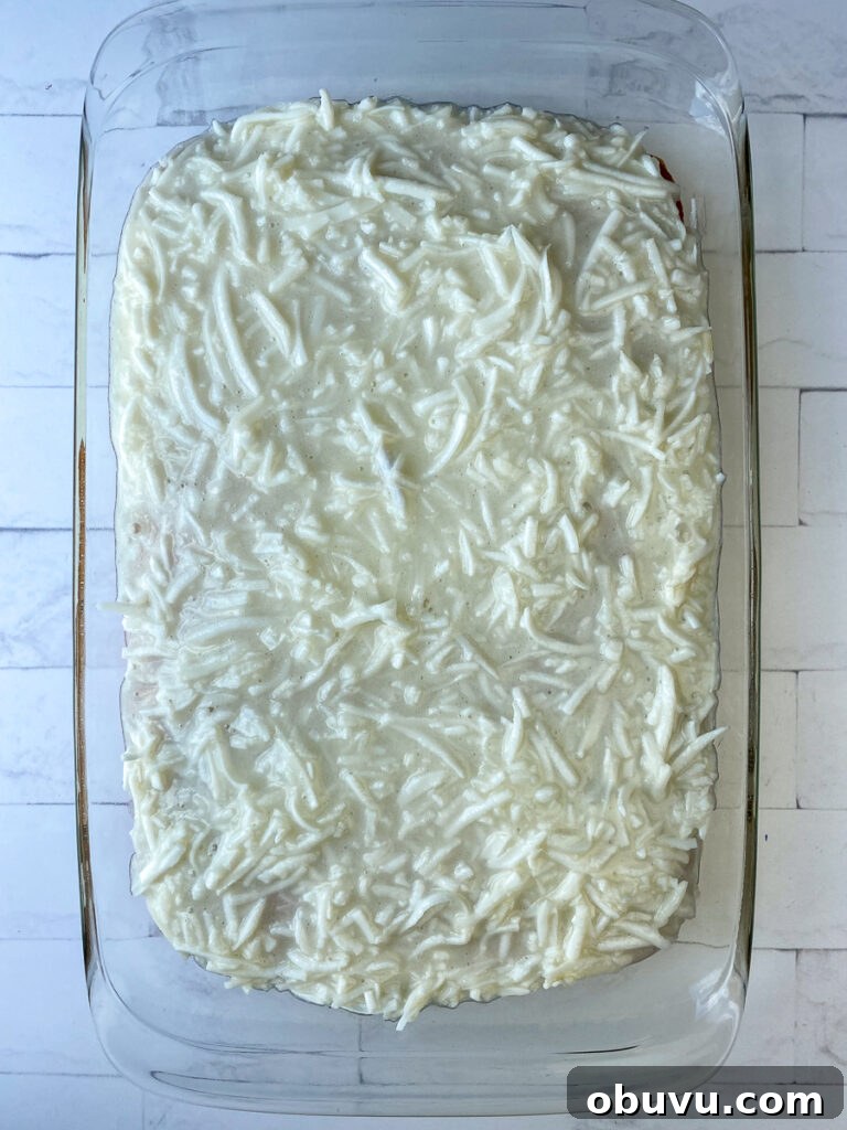 First layer of thick coconut and sour cream mixture on top of cake
