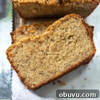 Moist Almond Flour Banana Bread Made with Oil 8 sliced almond flour bread face up on a white marble board.