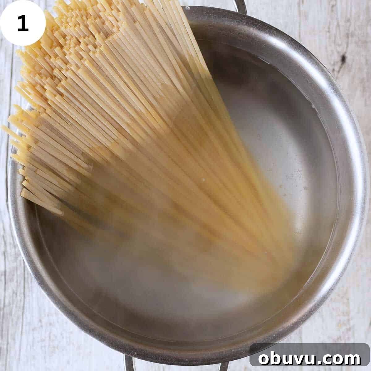 Linguine pasta in a pot of water.