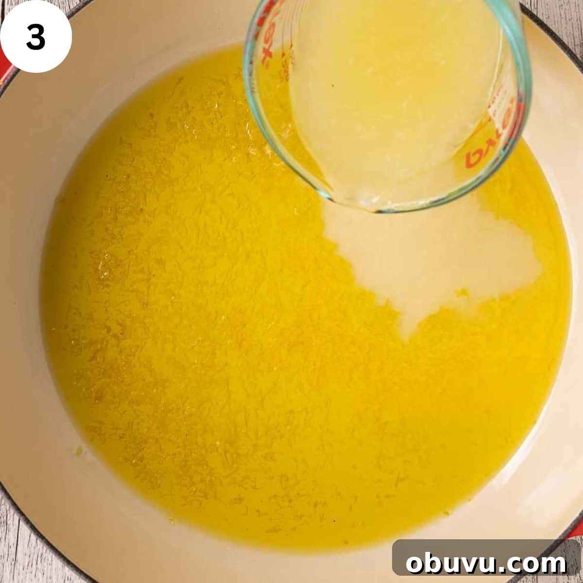 Adding lemon juice to melted butter and oil in a pan.