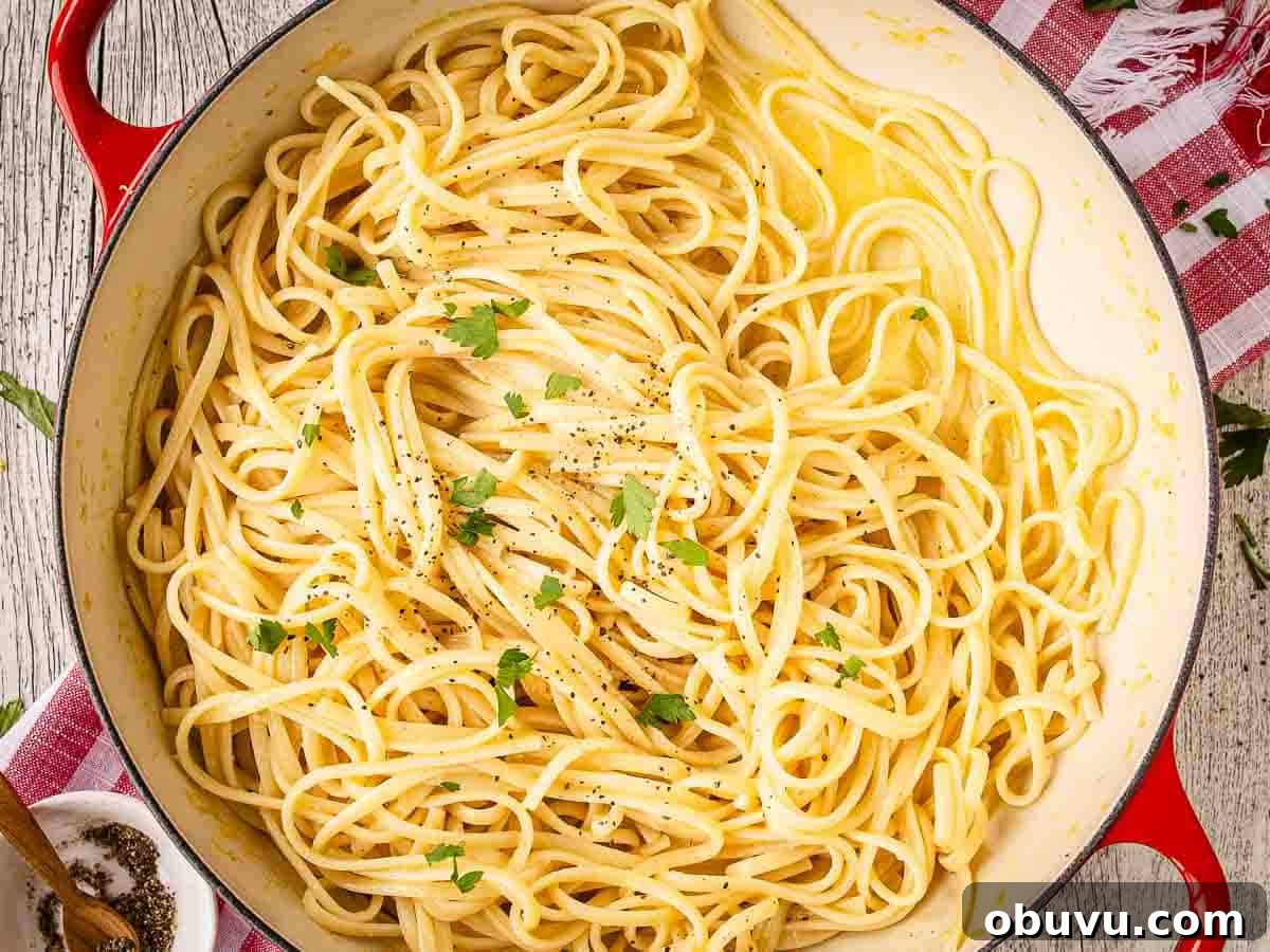 Cooked linguine pasta in a skillet viewed overhead.