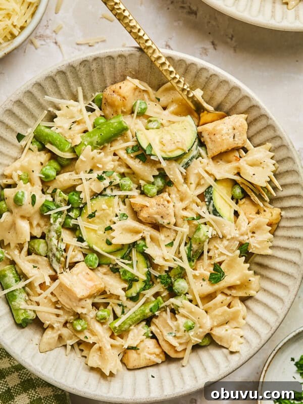 Gluten-Free Marry Me Chicken with Creamy Orzo 10 Boursin chicken pasta with spring veggies in a bowl with a gold fork