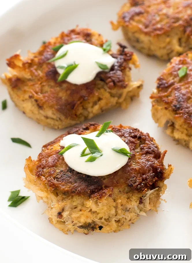 Crispy Crab Cakes with Zesty Lemon Aioli Recipe 5 top shot of crab cakes with lemon aioli dollop on top arranged on white plate
