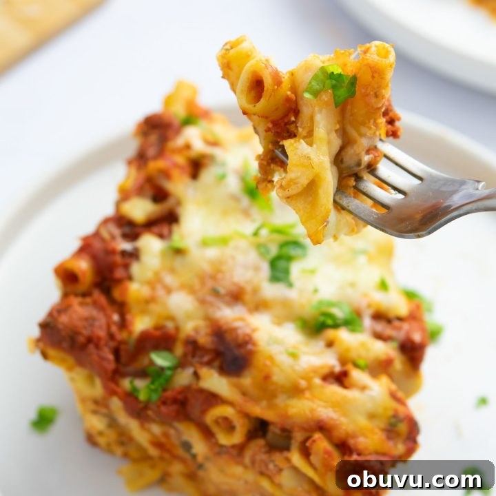 Week 13 Meal Plan: Group 2 Weekly Menu & Grocery List 4 Forkful of Cheesy Meatless Baked Ziti garnished with fresh parsley held above a serving of the ziti on a plate.