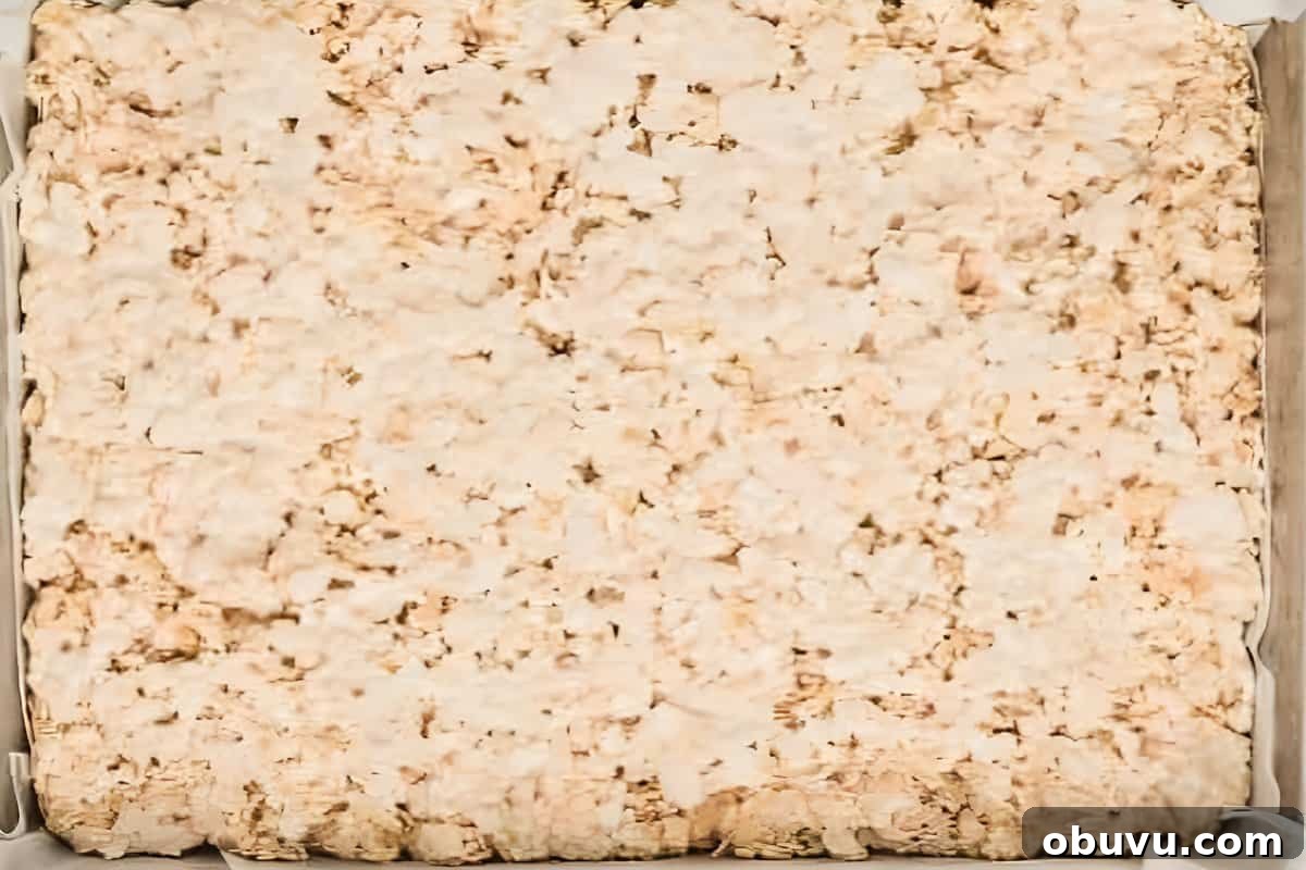 Easter Rice Krispie Treats Recipe with Colorful Spring Decorations 9 Rice Krispies marshmallow treat mixture flattened into a baking pan.