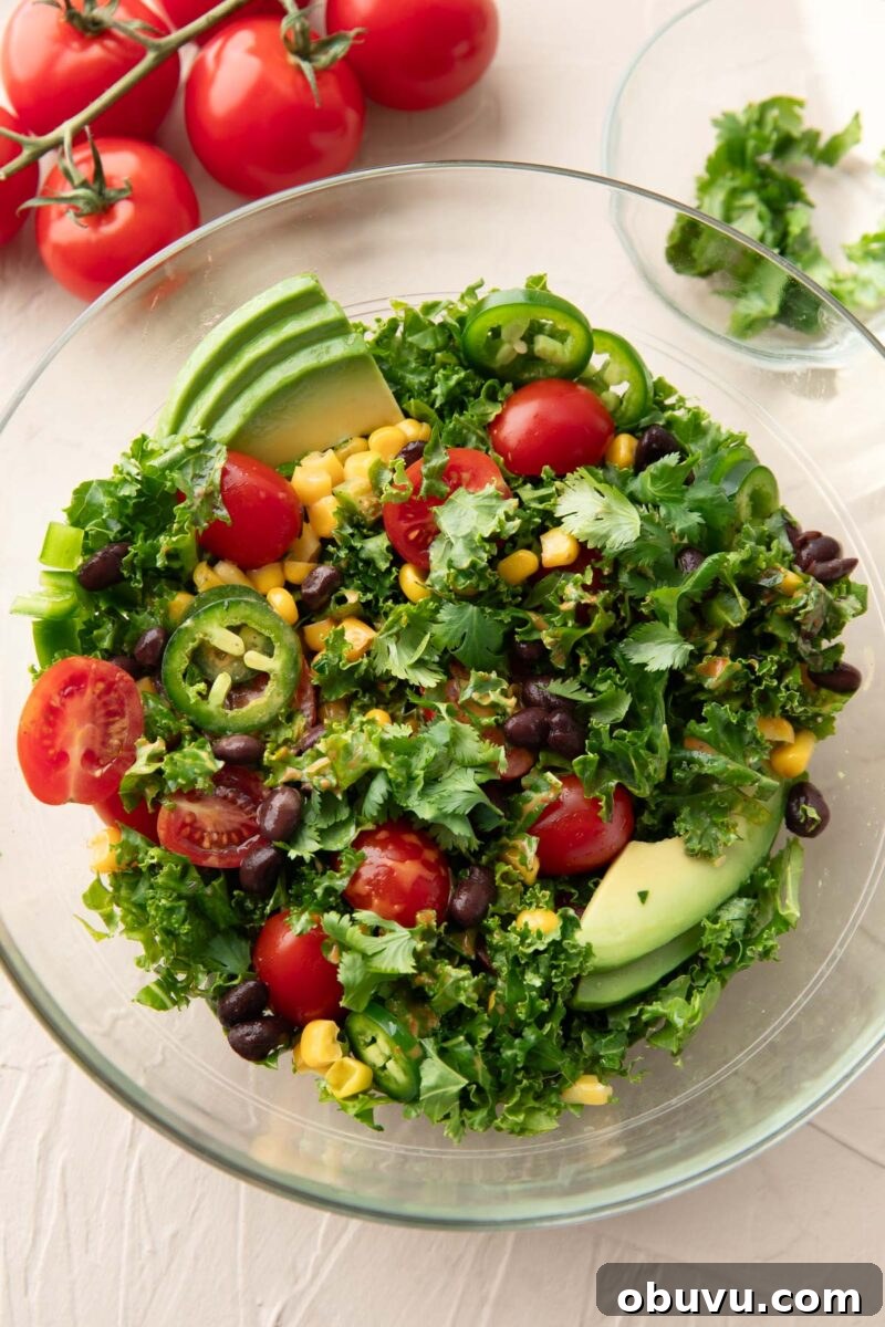 Chipotle Kale Salad Recipe with Smoky Lime Dressing 6 mixed up chipotle kale salad ingredients with dressing poured over