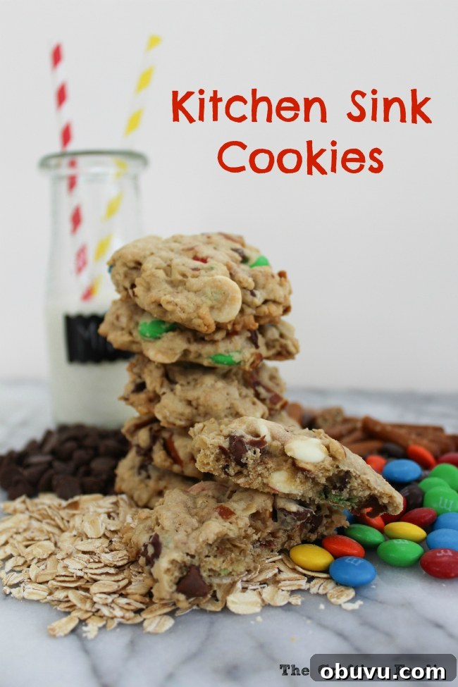 Creative Recipes for Using Leftover Halloween Candy 8 Chewy Kitchen Sink Cookies filled with chocolate chips, white chocolate, oatmeal, and M&M's.