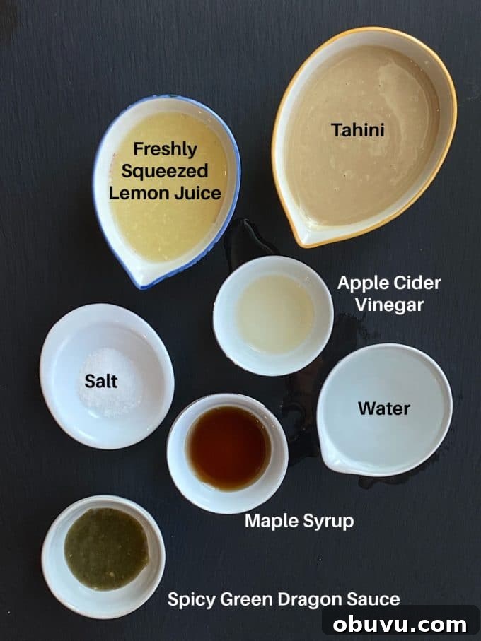 Ingredients to make Spicy tahini dressing labeled: tahini, lemon juice, water, maple syrup, apple cider vinegar, salt and green dragon sauce