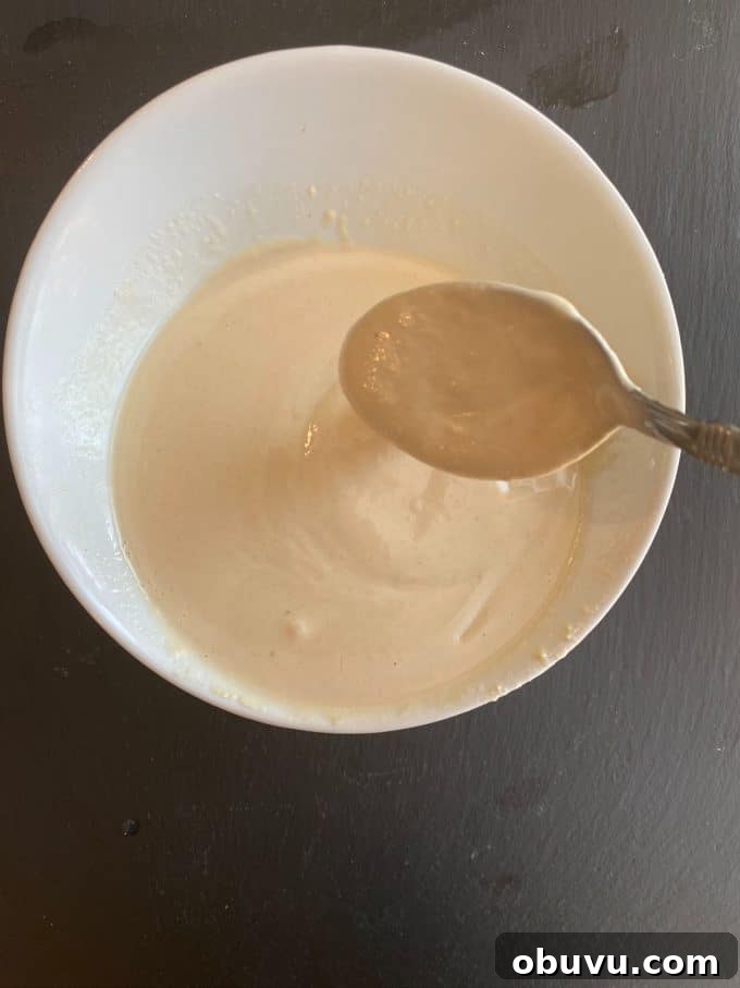 Mixing the tahini dressing in a bowl