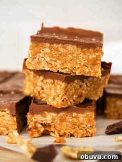 Aunt Deb’s Special K Bars Recipe — Crispy Cereal Treats 12 A stack of three Special K Bars on parchment paper.