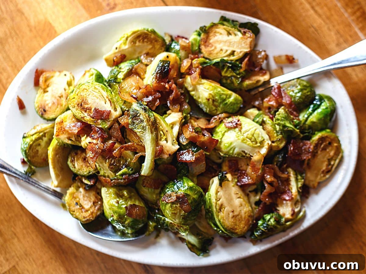 Crispy Oven-Roasted Brussels Sprouts with Balsamic Glaze 4 Roasted Brussels Sprouts with bacon on a white serving plate.