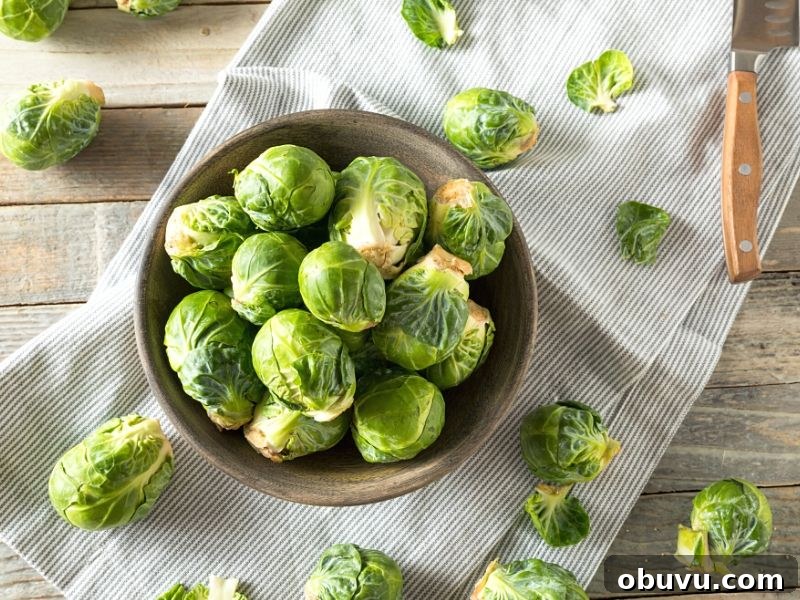 Crispy Oven-Roasted Brussels Sprouts with Balsamic Glaze 5 Raw Brussel sprouts in a bowl on a tea towel on the counter.