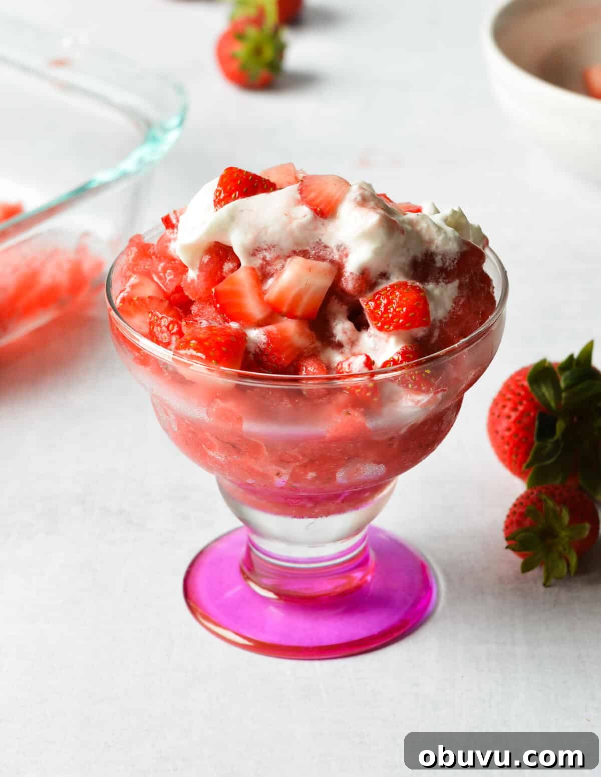 Strawberry & Passion Fruit Granita Recipe for Summer Refreshment 11 strawberry granita with whipped cream and strawberries on top.