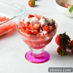 Strawberry & Passion Fruit Granita Recipe for Summer Refreshment 12 a cup with strawberry granita with whipped cream and strawberries on top.