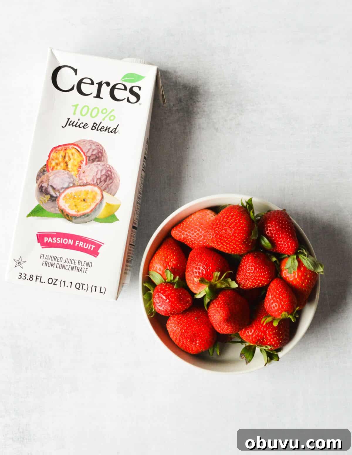 Strawberry & Passion Fruit Granita Recipe for Summer Refreshment 3 Cere's passion fruit juice and a bowl of fresh strawberries.