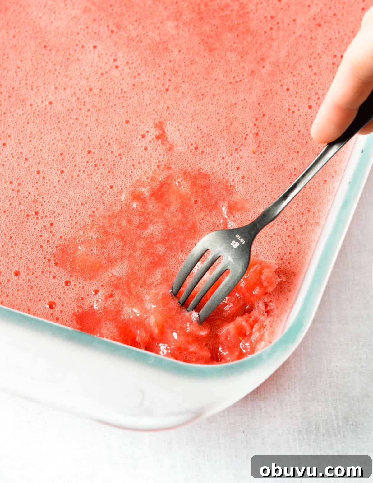 Strawberry & Passion Fruit Granita Recipe for Summer Refreshment 7 fork scraping the frozen bits in a granita