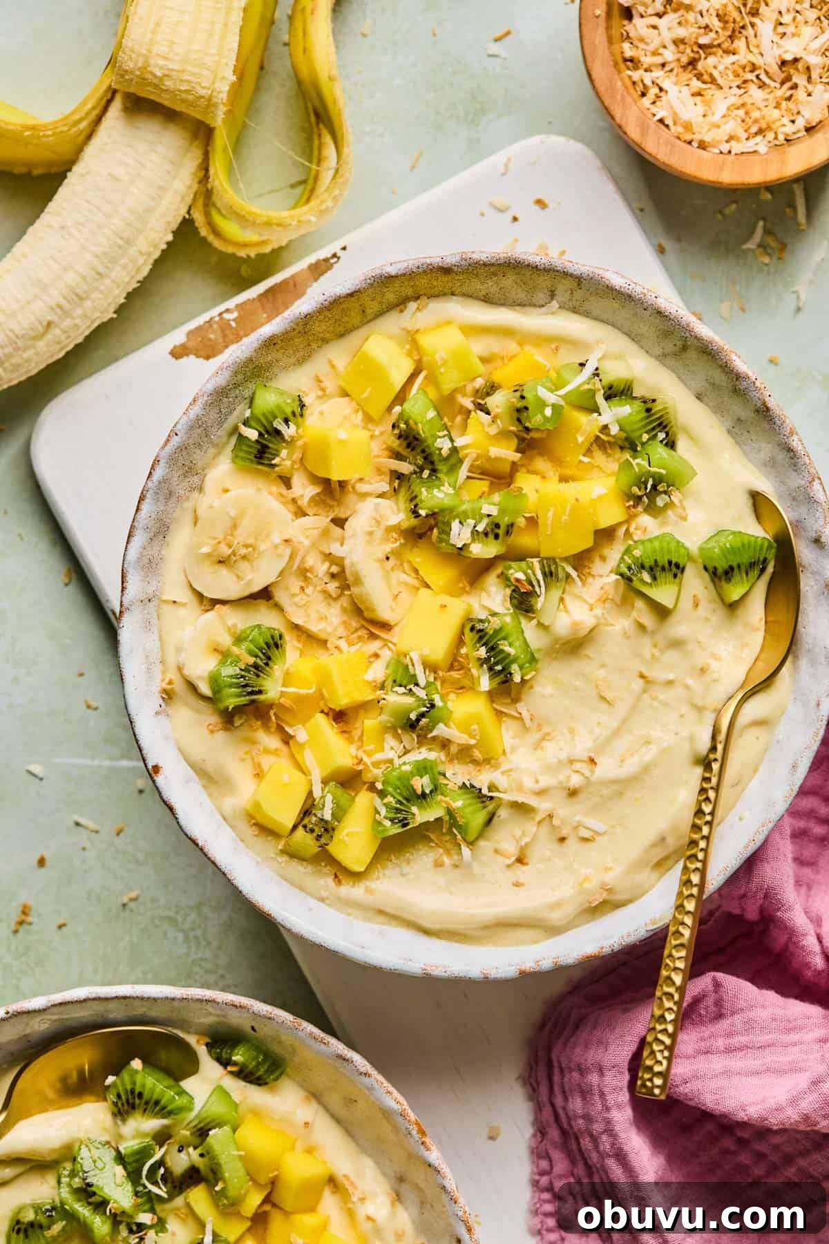 Garlic-Roasted Mini Peppers: Flavorful Oven-Roasted Snack or Side 11 coconut smoothie bowl with toppings on a counter next to a peeled banana and bowl of toasted coconut