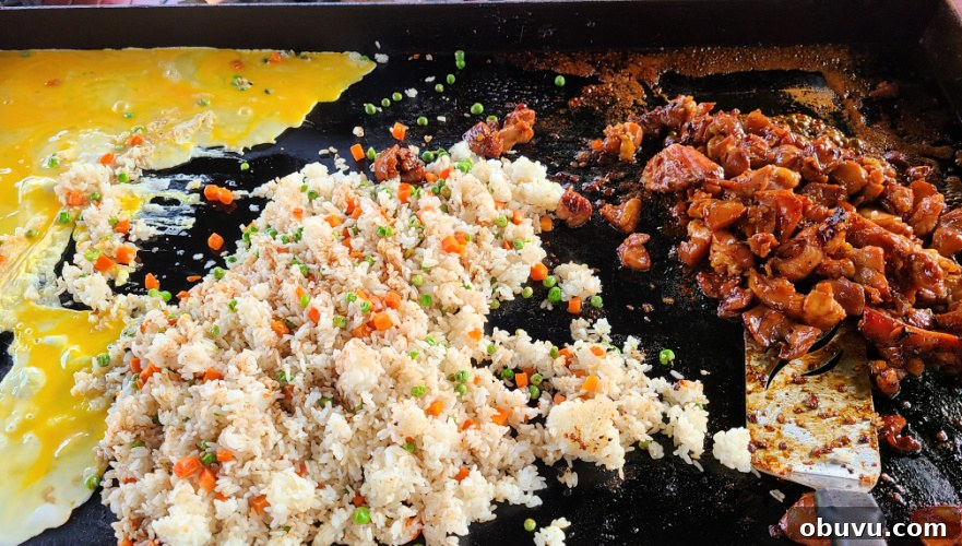 Teriyaki Chicken Fried Rice Made on a Blackstone Griddle 5 Teriyaki Chicken Fried Rice cooking on the griddle