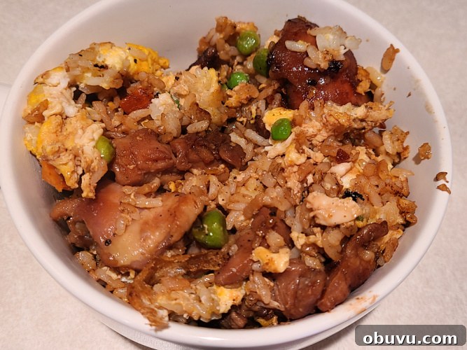 Teriyaki Chicken Fried Rice Made on a Blackstone Griddle 7 Teriyaki Chicken Fried Rice served in a white bowl