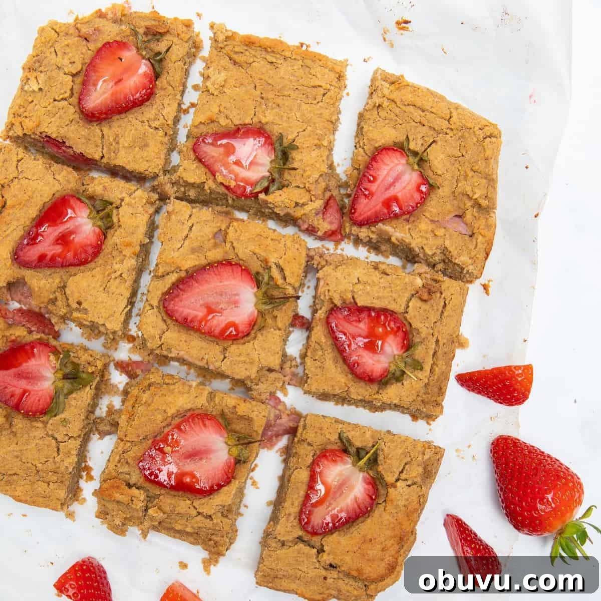 Chewy Peanut Butter Blondies Recipe for Rich, Gooey Bars 2 Peanut Butter Blondies with strawberries on top.