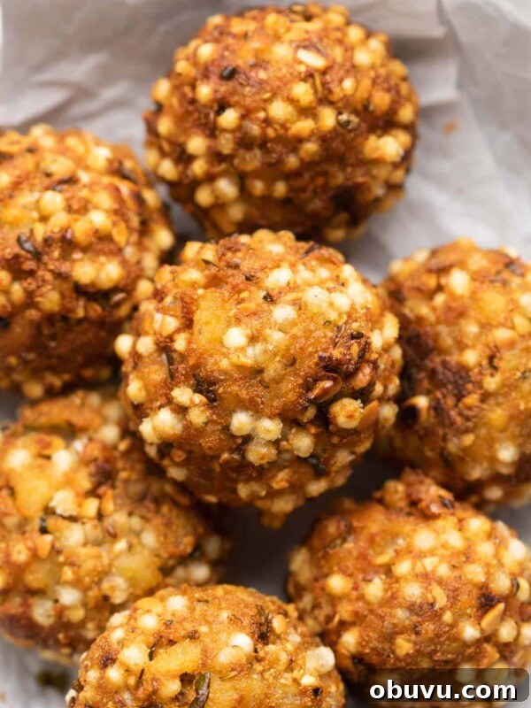 Closeup of sabudana vada bombs stuffed with paneer stacked on top of one another