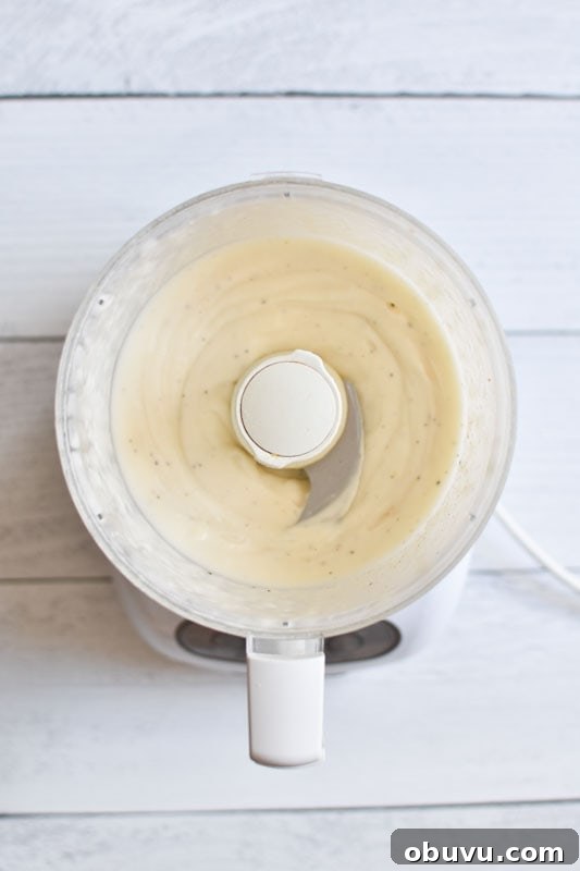 Whole30-Friendly Tartar Sauce Recipe for Seafood and Dips 3 Whipped mayo in a food processor on a white board