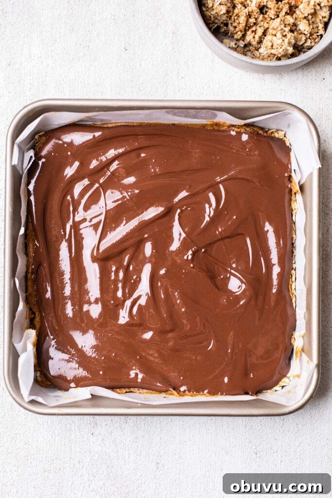 Chocolate fudge layer added on top of date layer.